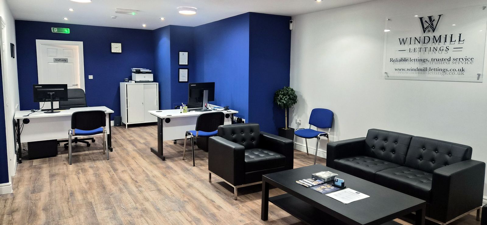 Inside the Windmill Lettings office at 109 High Street, Bromsgrove: desks, a seating area with leather sofas, and the Windmill Lettings sign on the wall